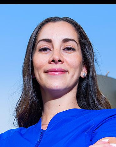 Es la foto de perfil de una cirujana plástica en Huixquilucan de Hospital Angeles Lomas. Usa un uniforme médico azul, está sonriendo y tiene el cabello lacio y oscuro.