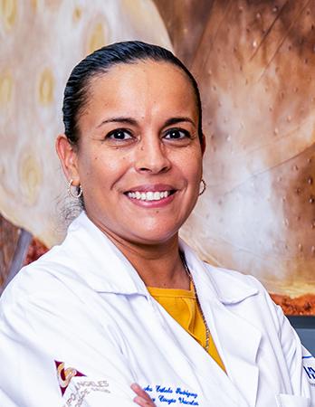 Es la foto de perfil de una angióloga y cirujana vascular en León de Hospital Angeles León. Utiliza una bata blanca con una blusa amarilla, tiene el cabello recogido y de color negro.
