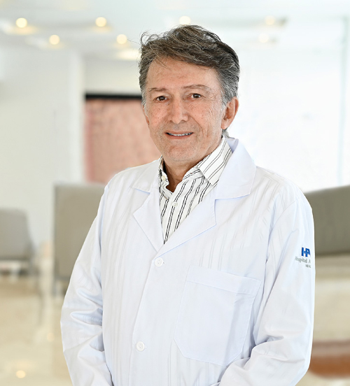 Es la foto de perfil de un cardiólogo intervencionista en Xalapa de Hospital Angeles Xalapa. Usa una bata blanca y una camisa de rayas blanca con verde. Tiene el cabello negro.