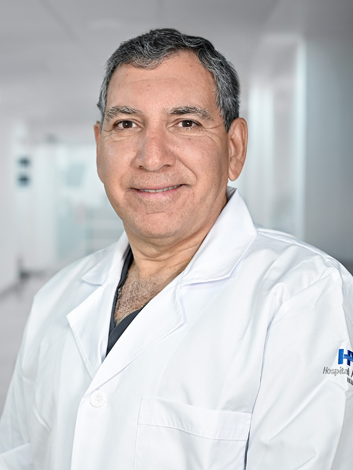 Es la foto de perfil de un pediatra especialista en medicina crítica pediátrica en Guadalajara de Hospital Angeles Del Carmen. Tiene una bata blanca, camisa y una corbata. 