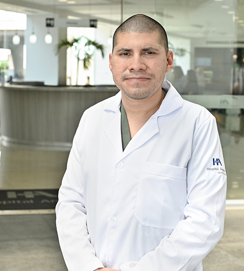 Es la foto de perfil de un médico en medicina crítica en Ciudad de México de Hospital Angeles Acoxpa. Usa una bata blanca con un uniforme médico color verde militar. Tiene el cabello muy muy corto.