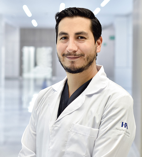 Es la foto de perfil de un otorrinolaringólogo en Querétaro de Hospital Angeles Centro Sur. Usa una bata blanca con una camisa azul marino.