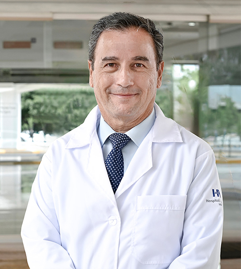 Es la foto de perfil de un ginecólogo y obstetra en Culiacán de Hospital Angeles Culiacán. Utiliza una bata blanca, camisa azul y corbata azul eléctrico.