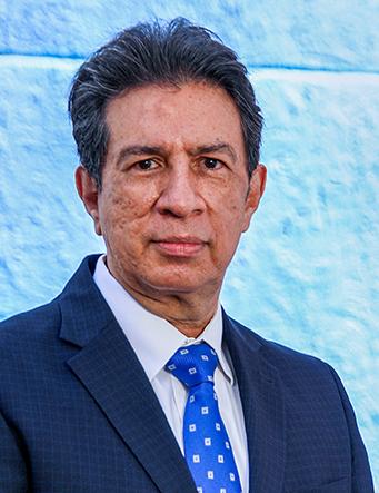 Es la foto de perfil de un ginecólogo y obstetra en León de Hospital Angeles León. Usa un saco azul marino, camisa blanca y corbata azul eléctrico.