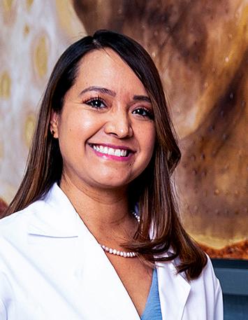 Es la foto de perfil de una geriatra en León de Hospital Angeles León. Tiene una bata blanca, blusa azul, collar de perlas y cabello largo suelto.