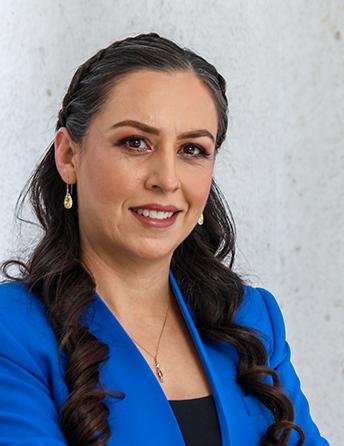 Es la foto de perfil de un psicoanalista en León de Hospital Angeles León. Usa un saco azul con una blusa negra. Tiene el cabello largo y ondulado.