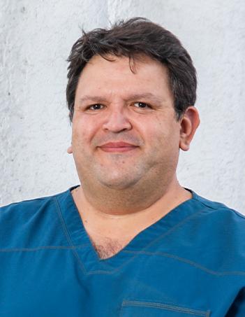 Es la foto de perfil de un cirujano de tórax en León de Hospital Angeles León. Tiene el cabello castaño. Usa un uniforme médico color azul.